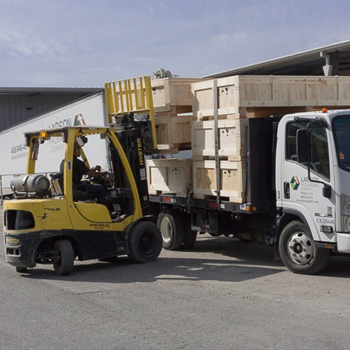 Custom wooden crates being loaded on to the LPC truck for delivery