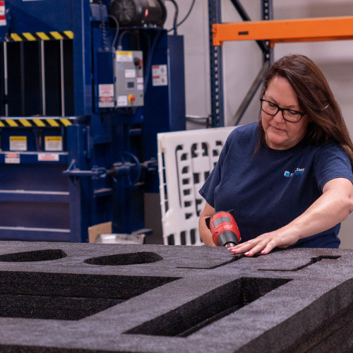 LPC team member manufacturing a foam cushioning system for packaging